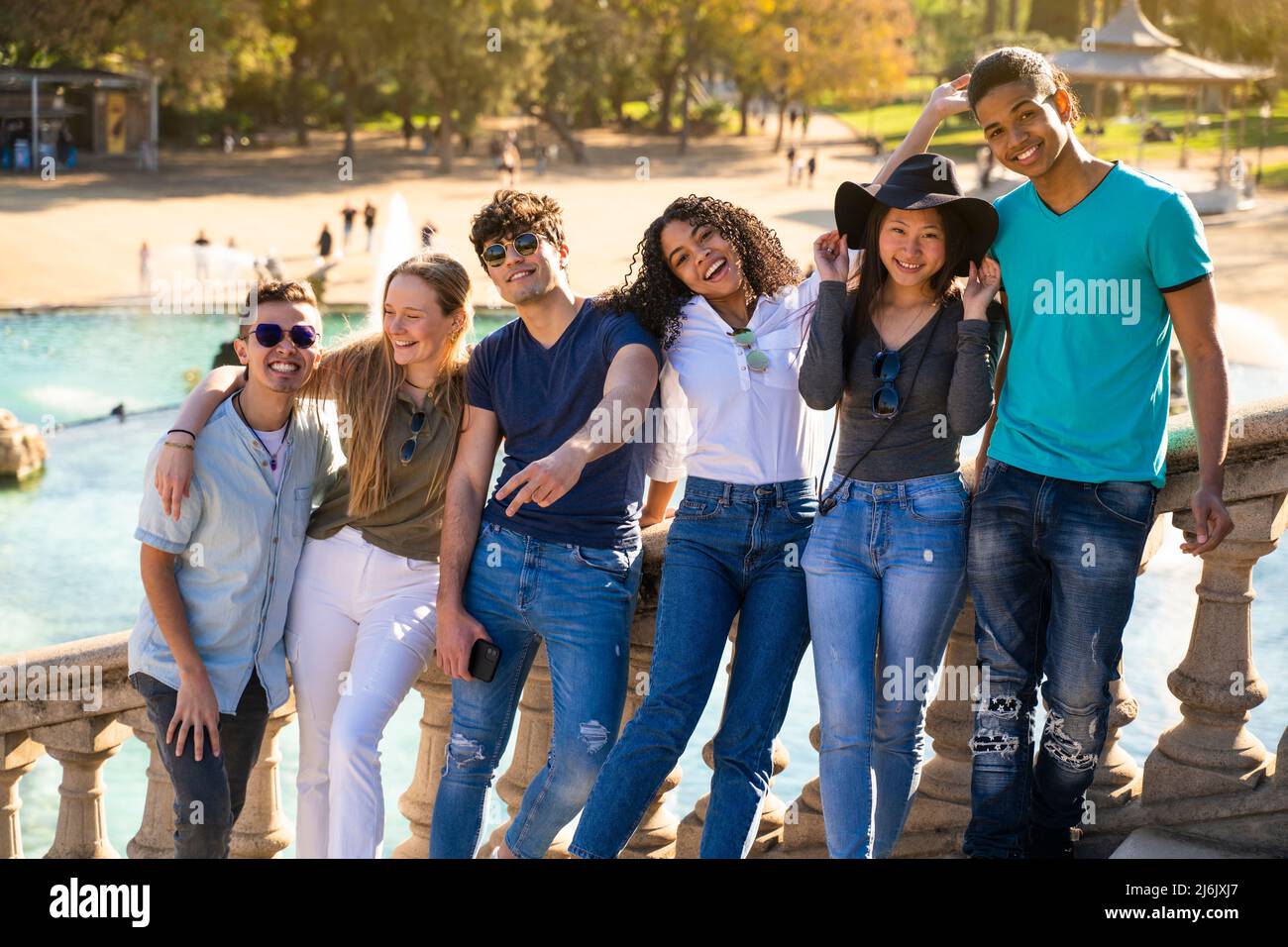 Groupe de jeunes étudiants multiraciaux souriant à la caméra sur quelques escaliers Banque D'Images