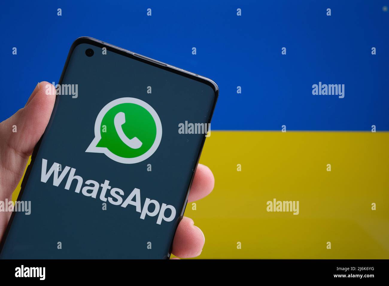 Logo de l'application WhatsApp sur le smartphone et drapeau ukrainien sur l'arrière-plan. Concept. Stafford, Royaume-Uni, 20 mars 2022 Banque D'Images