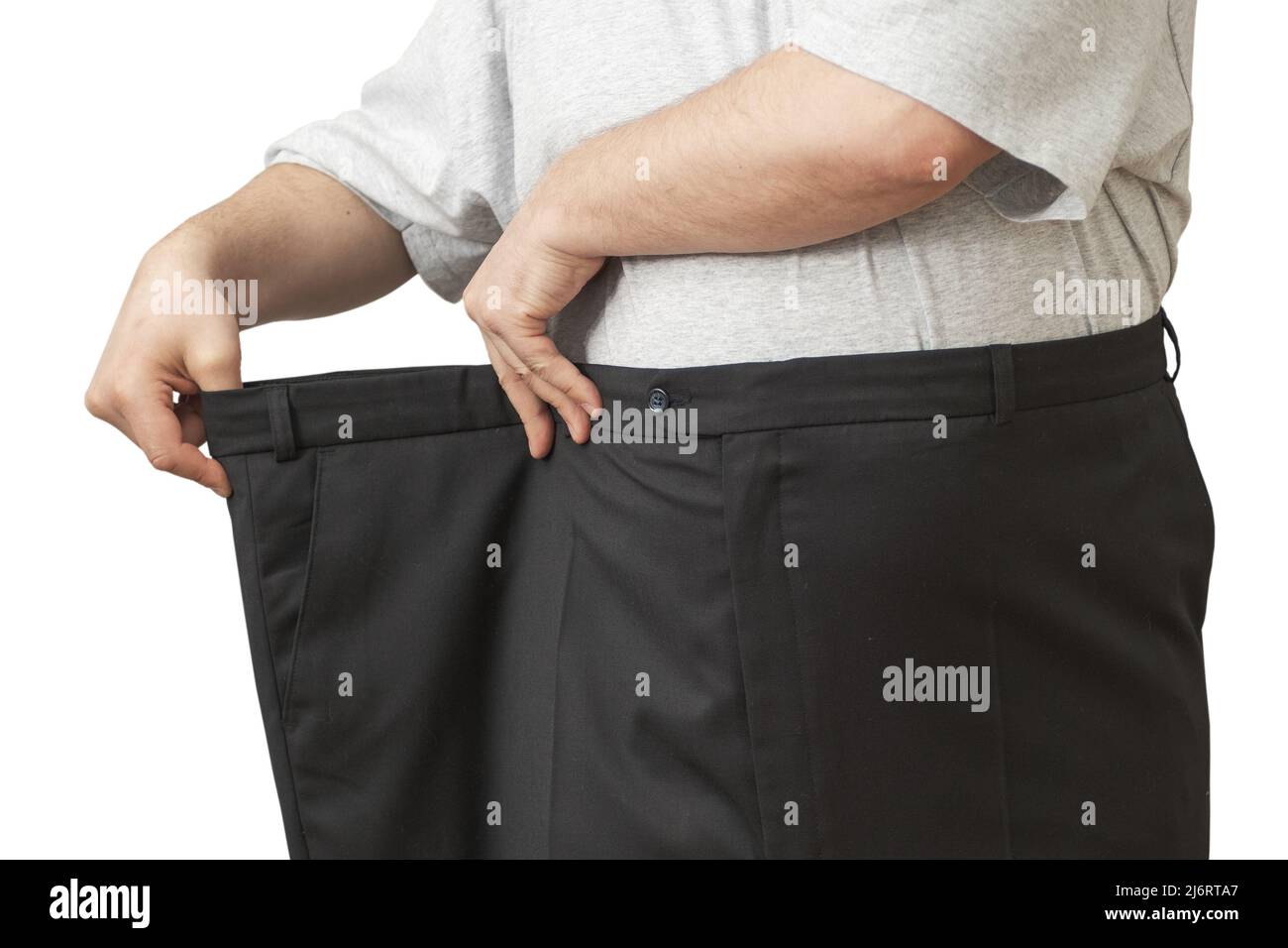 L'homme tire sur son grand pantalon à la taille. Montre comment il a perdu  du poids Photo Stock - Alamy