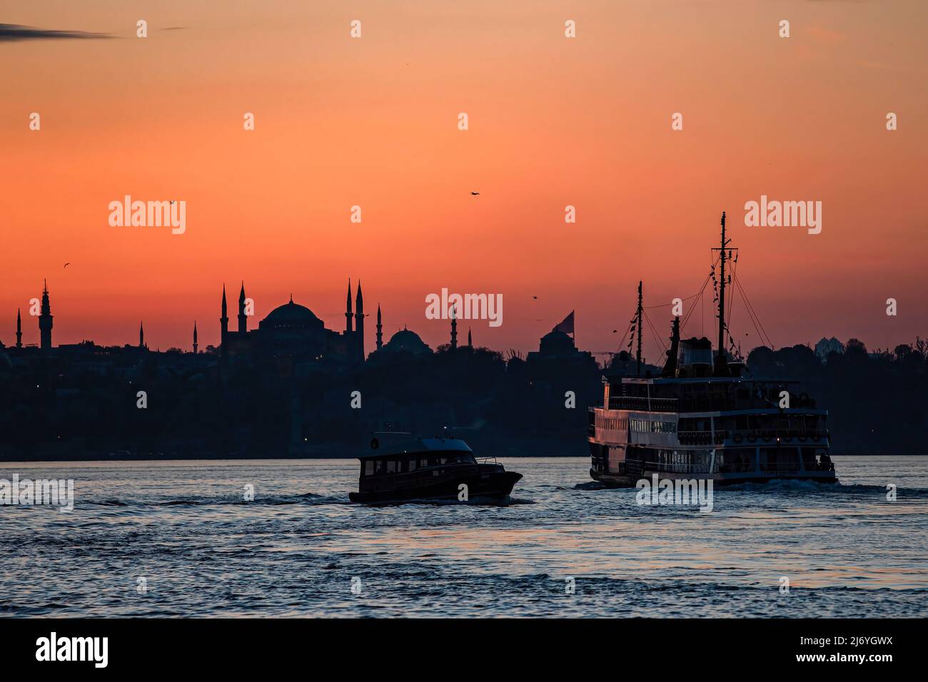 Un ferry pour les lignes de la ville vu au coucher du soleil. Banque D'Images