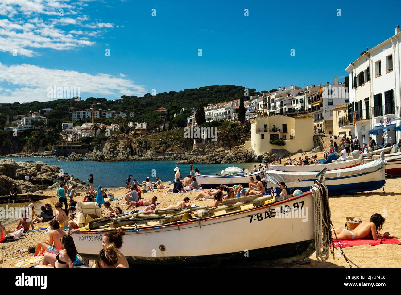 Calella de Palafrugell, Espagne - 25 avril 2022 : bateaux de pêche et touristes sur la plage de Port Bo, vieille ville de Calella de Palafrugell, sur la Costa Brava Banque D'Images