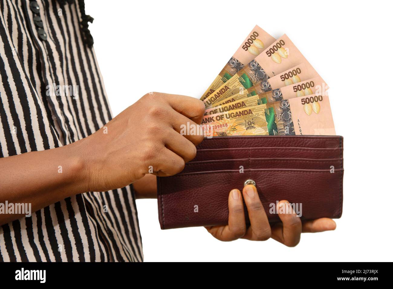 Main de la femme équitable porte-monnaie brune avec des notes de shilling  ougandaises, main retirant l'argent de la bourse isolée sur blanc. Retirer  l'argent de la poche Photo Stock - Alamy