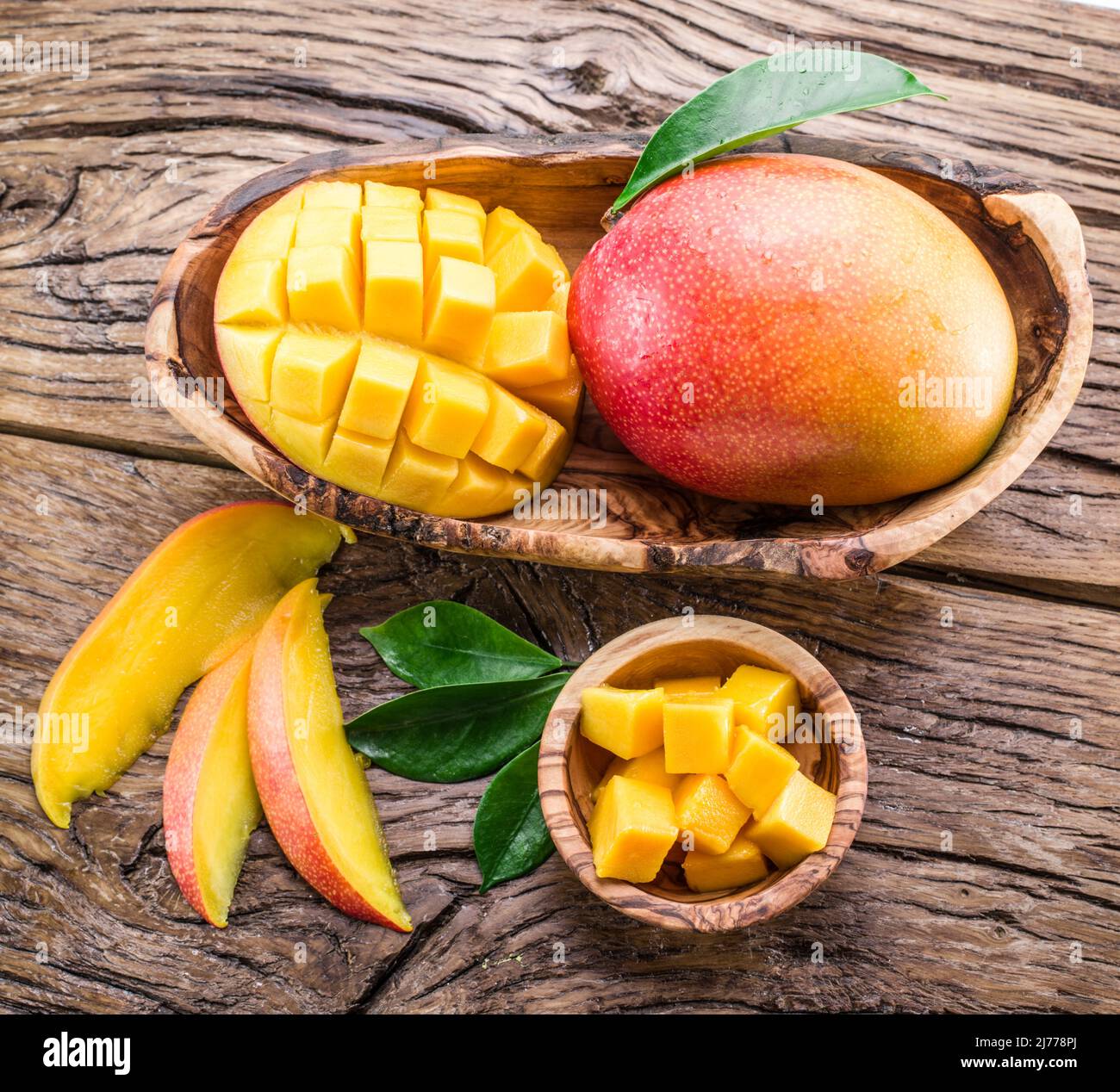 Fruits de Manfo et tranches de mangue sur la table en bois. Vue de dessus. Banque D'Images