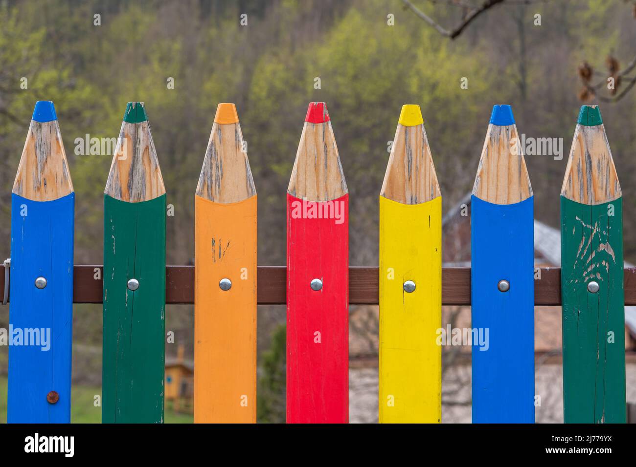 Clôture décorative en bois colorée qui ressemble à des crayons ou des crayons aiguisés Banque D'Images