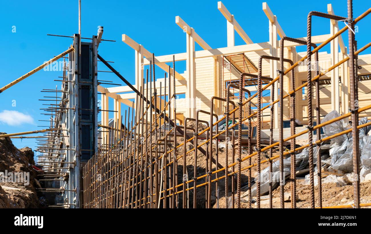 Barre d'armature pour concrétiser une clôture sur le site de construction d'une maison privée à l'extérieur de la ville. Les barres d'armature en fer sont attachées pour la fondation de clôture fra Banque D'Images