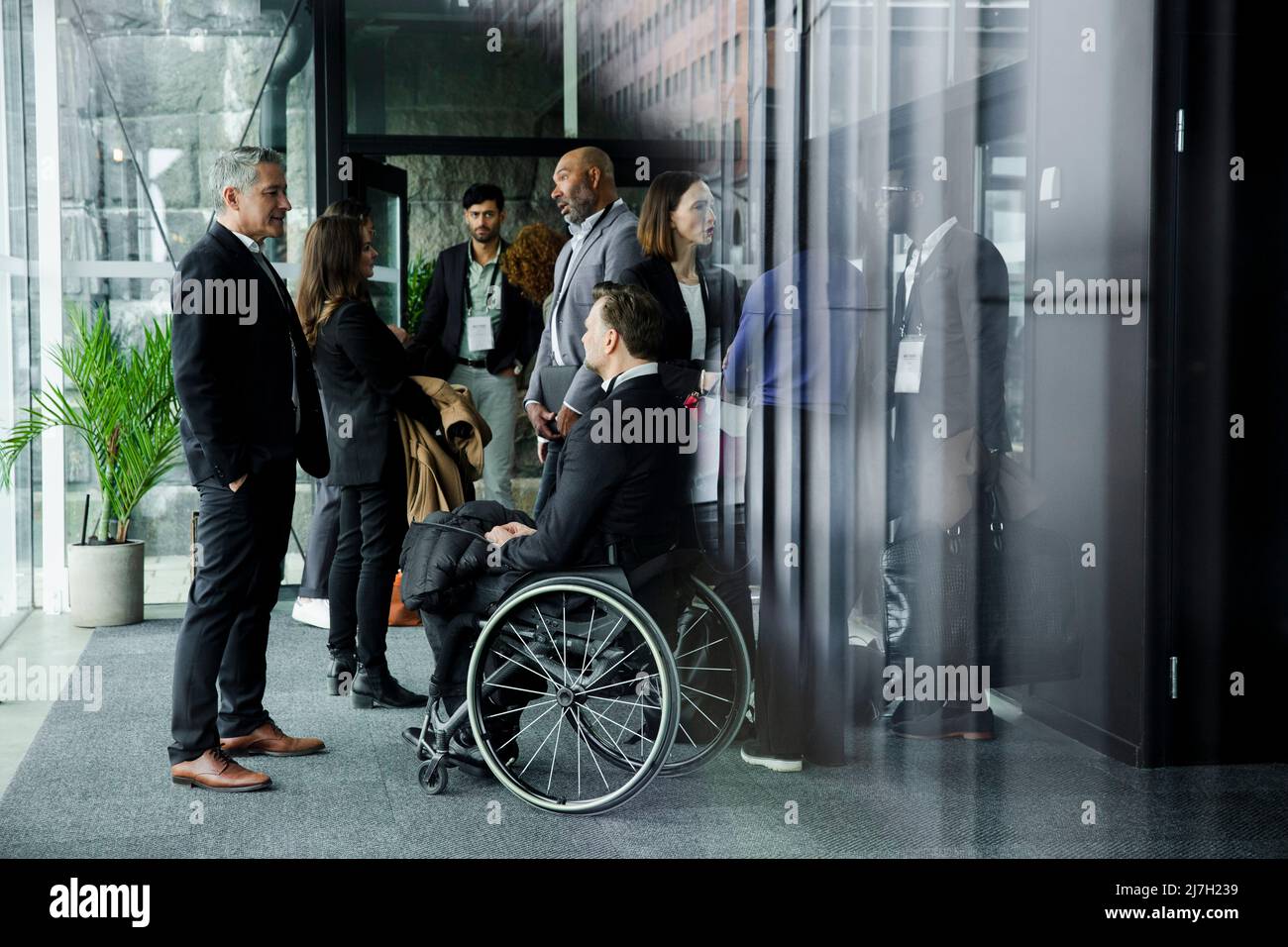 Les professionnels d'affaires discutent pendant le séminaire dans le couloir du centre de conférence Banque D'Images