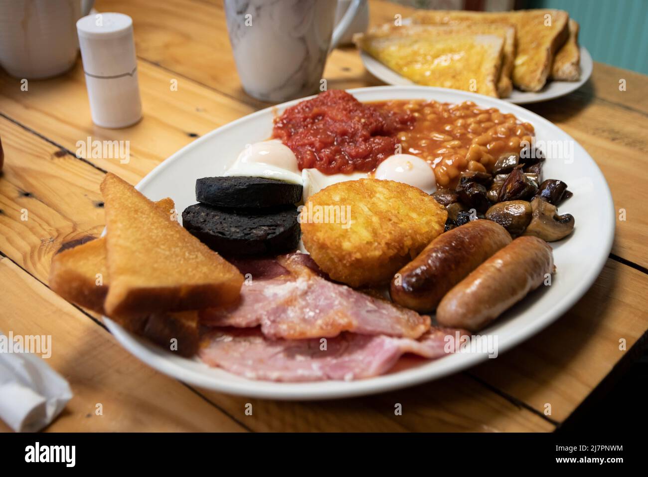 Un petit déjeuner anglais complet - également appelé « friture » - composé d'œufs, saucisses, bacon, tomates, champignons, haricots, pain frit, pot de haschbruns Banque D'Images