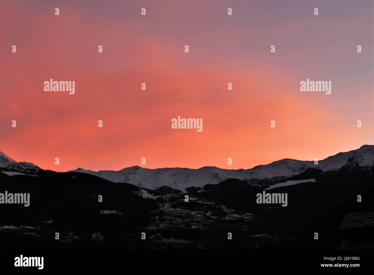 alpes italiennes au coucher du soleil. Magnifique coucher de soleil dégradé orange, rose et violet sur fond de montagnes enneigées silhouettées. (Aoste, Italie) Banque D'Images