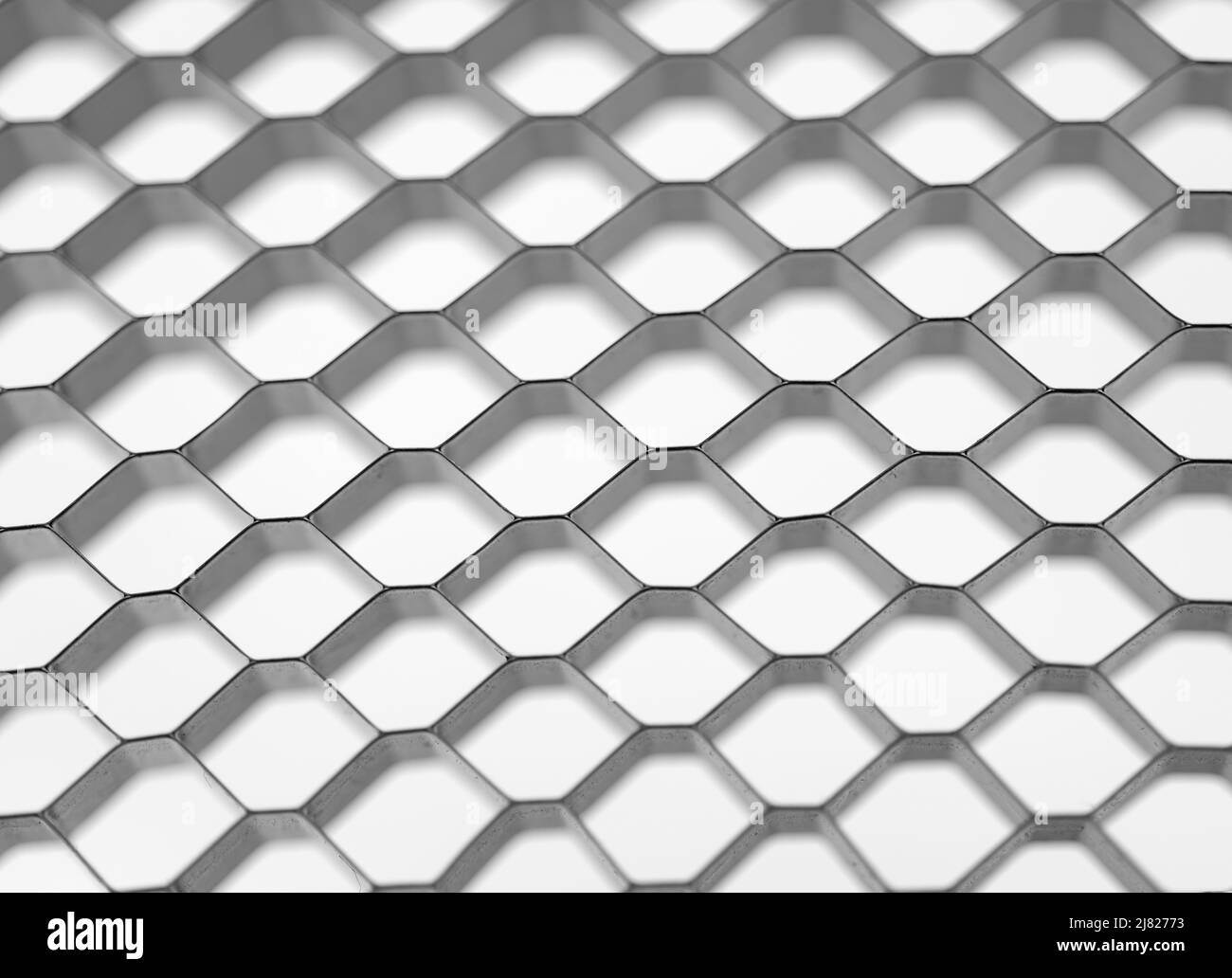 Mosaïque en nid d'abeille, fond blanc. Structure géométrique des cellules de maillage. Arrière-plan blanc abstrait avec grille hexagonale. Banque D'Images