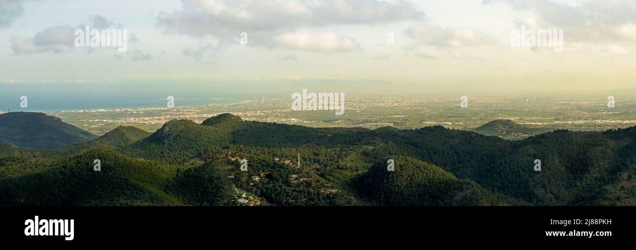 Vue panoramique sur les montagnes boisées de la Sierra de Calderona depuis le sommet de Garbí avec la ville de Valence en arrière-plan, Espagne. Environnement Banque D'Images