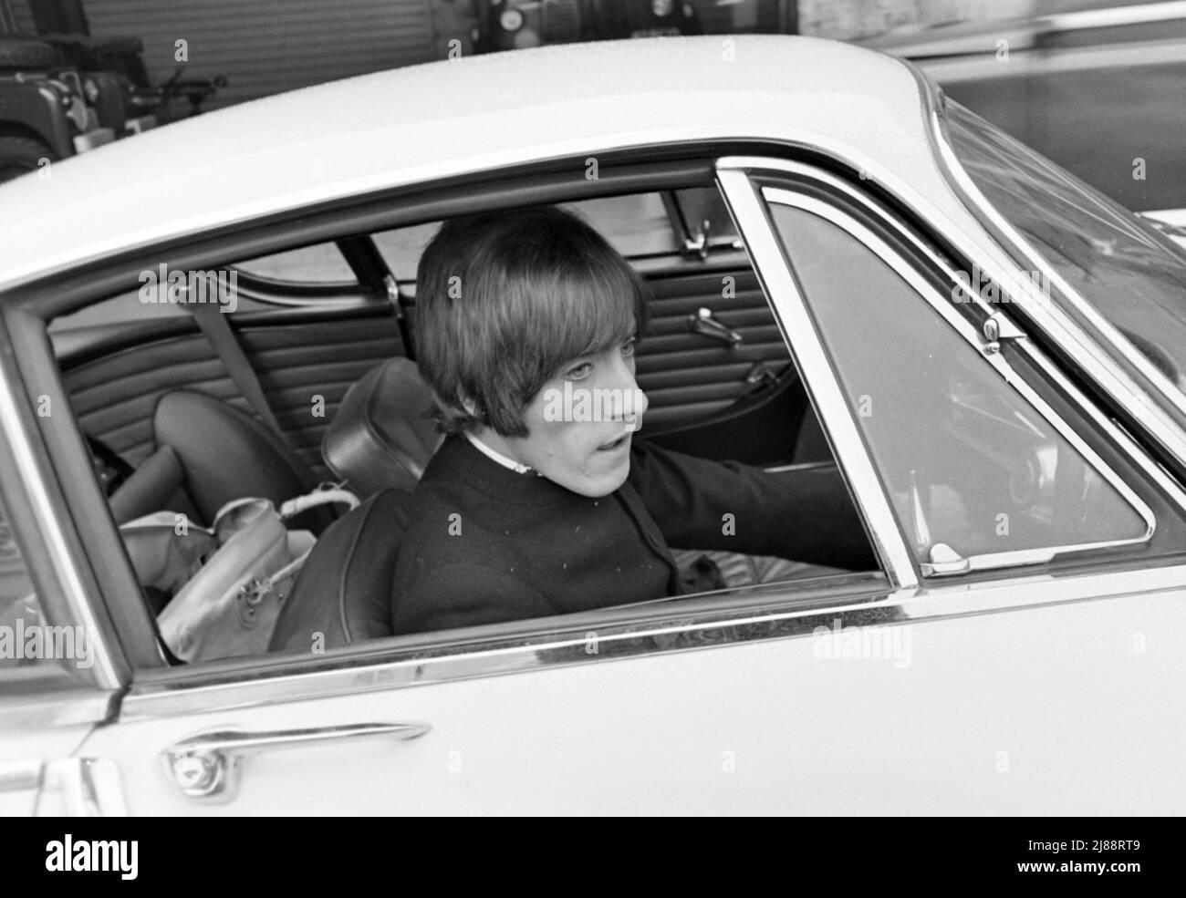 LE CHANTEUR ROGER Daltrey de L'OMS avec son coupé Volvo P1800 en novembre 1966. Le groupe venait de terminer un enregistrement en direct pour la télévision allemande sur le terrain du siège du Duc de York à Chelsea, Londres. Photo : Tony Gale Banque D'Images