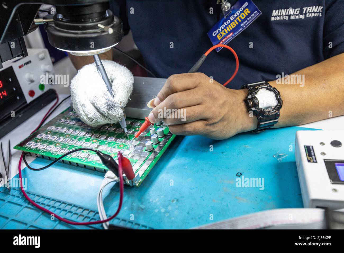 Bangkok, Thaïlande. 14th mai 2022. Un membre du personnel répare une carte mère de mineur au stand de réparation de mineur ASIC au salon Thailand Crypto Expo 2022 au centre international de commerce et d'exposition de Bangkok (BITEC) le 14 mai 2022 à Bangkok, Thaïlande. (Photo de Guillaume Payen/SOPA Images/Sipa USA) crédit: SIPA USA/Alay Live News Banque D'Images