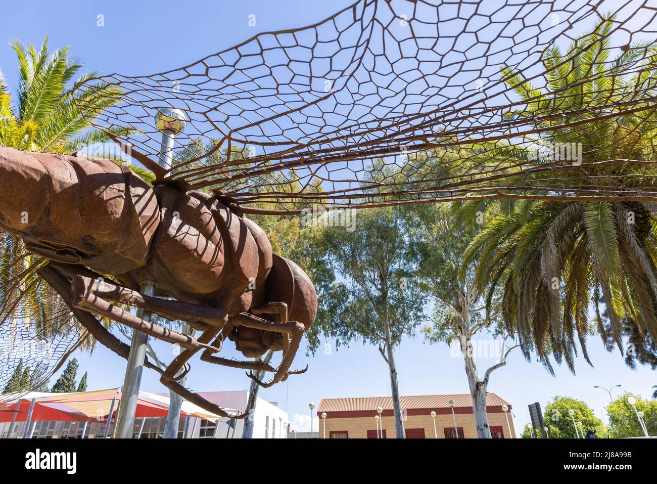 Huelva, Espagne - 28 avril 2022 : vue partielle du monument d'une libellule en acier corten, dans le Campus de "El Carmen" de l'Université Huelva Banque D'Images