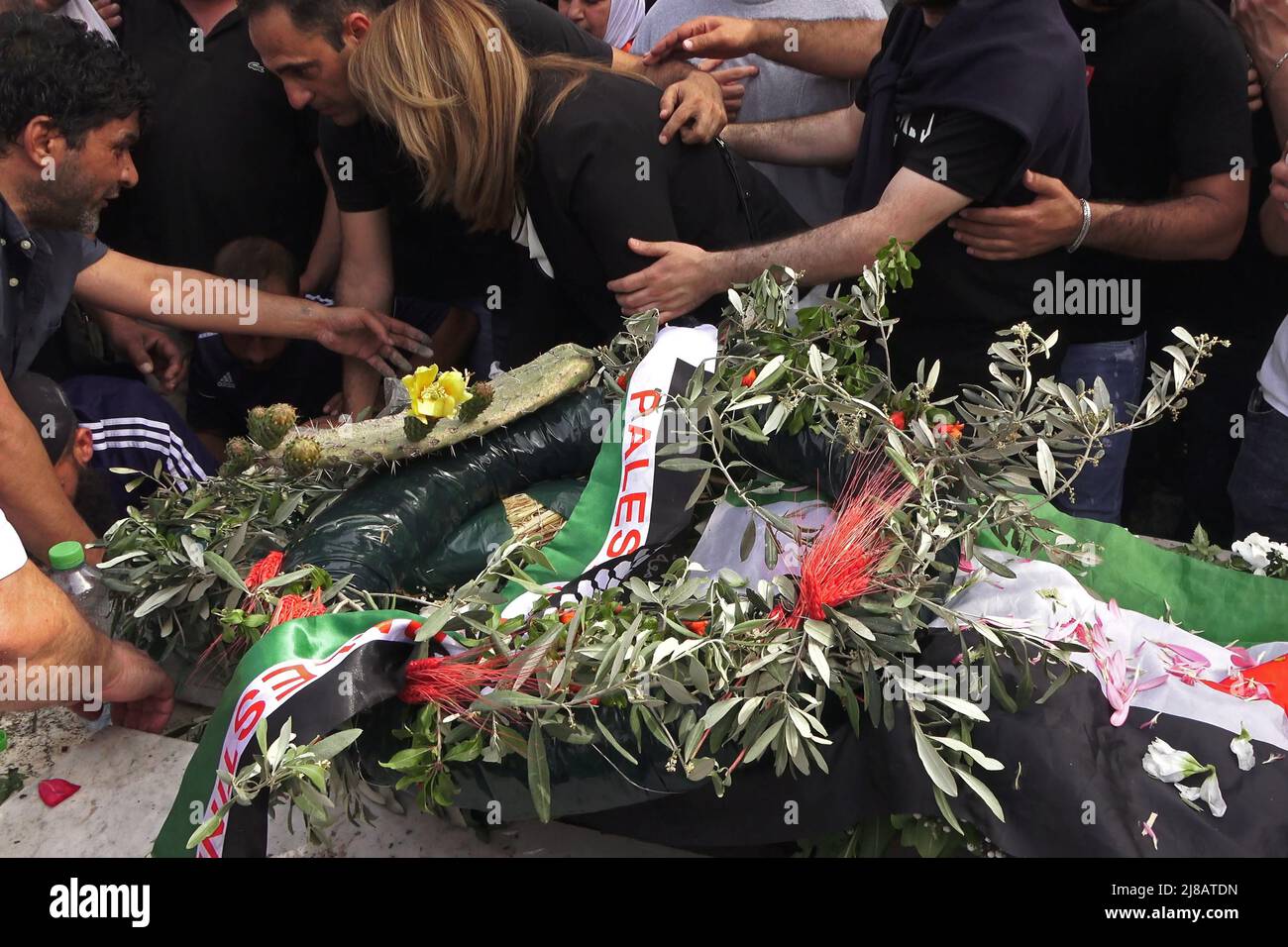 JÉRUSALEM, ISRAËL - 13 mai: Des membres de la famille pleurent lors de l'enterrement du journaliste d'Al-Jazeera Shireen Abu Akleh pleurent dans un cimetière chrétien de la montagne Sion, sur 13 mai 2022, à Jérusalem, en Israël. La journaliste palestinienne américaine Shireen Abu Akleh a été tuée par balle alors qu'elle couvrait un raid militaire israélien dans la ville de Jénine, en Cisjordanie. Banque D'Images
