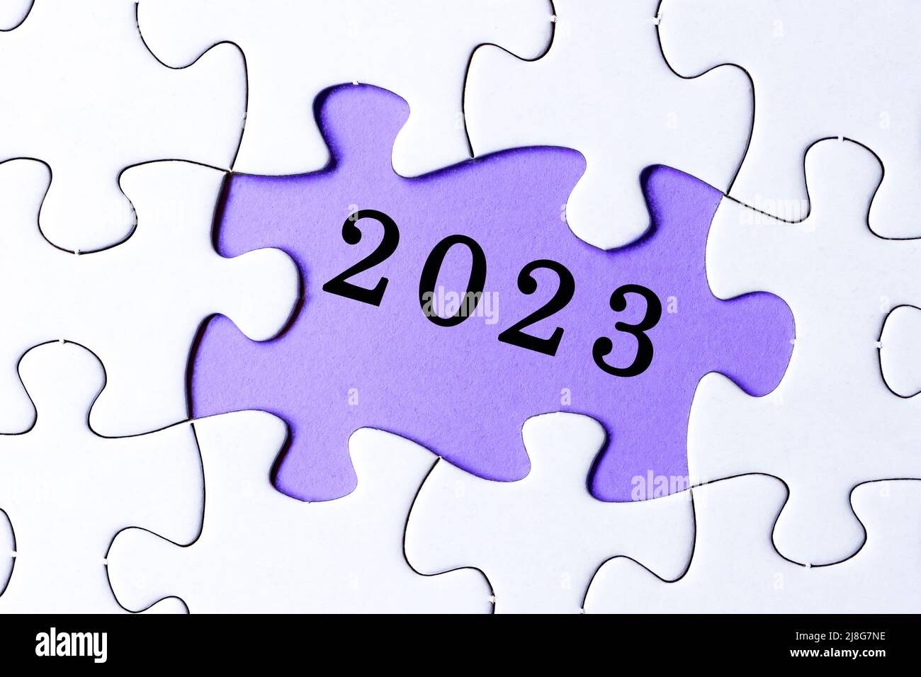 Puzzle blanc avec 2023 textes sur fond violet. Concept de la nouvelle année. Banque D'Images