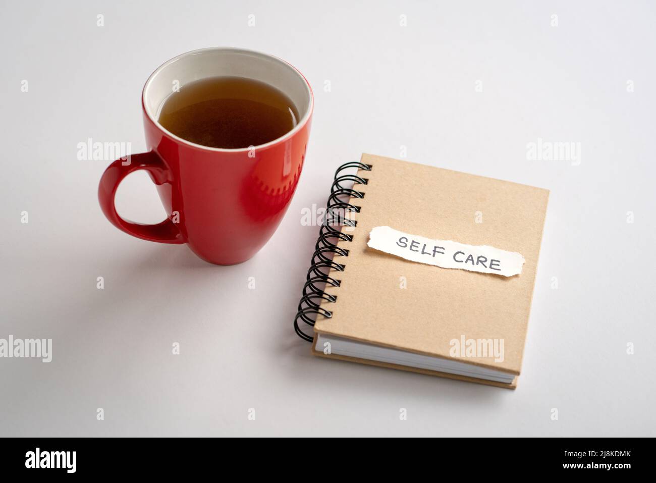 Soin de soi, texte sur un morceau de papier, sur un bloc-notes à côté d'une tasse de café. Concept d'auto-soin ou d'amour-propre. Banque D'Images