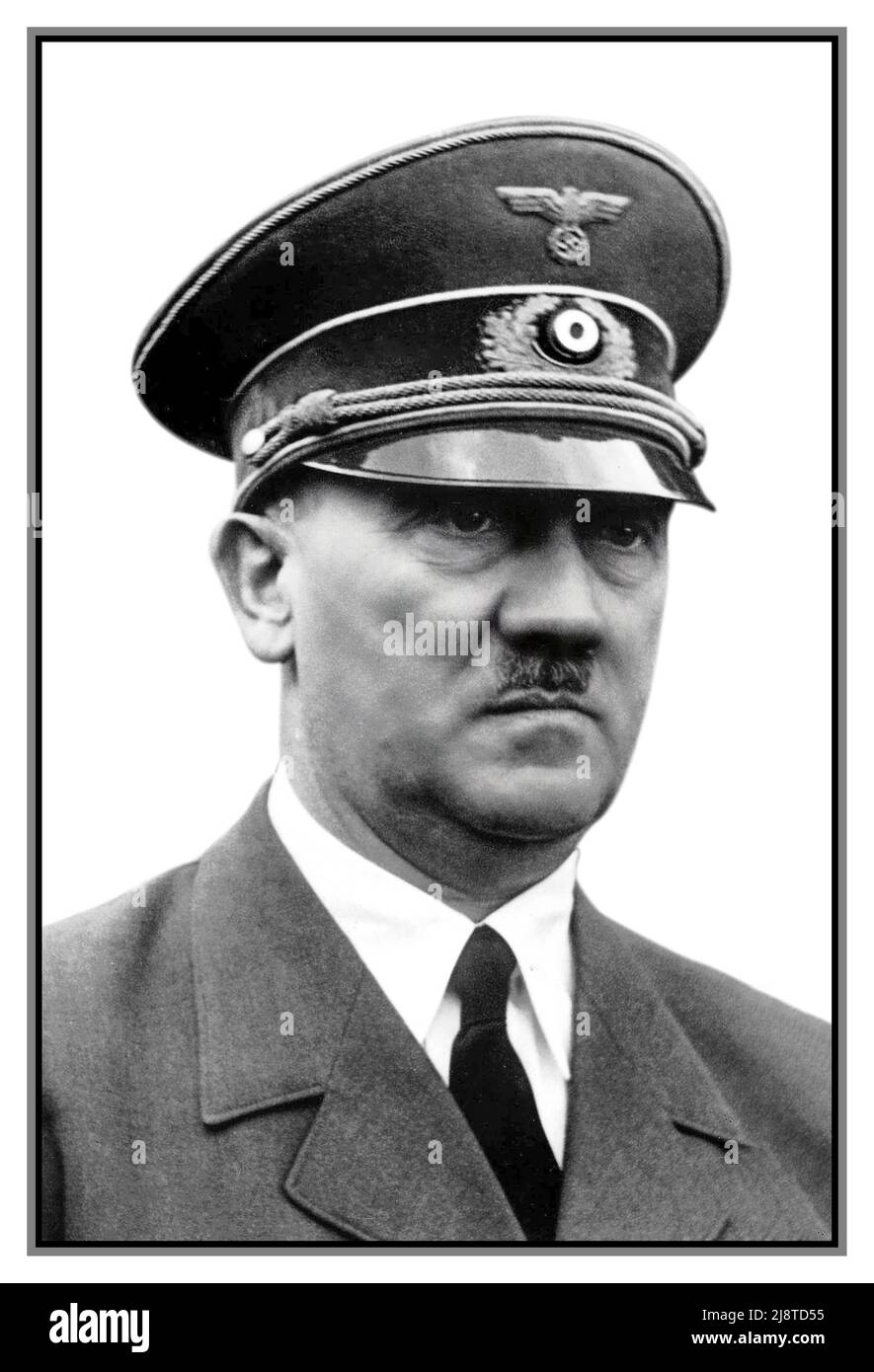 1940s Adolf Hitler Fuhrer und Reichskanzler en uniforme avec chapeau à pic. Lumière naturelle Portrait de reportage fort avec fond blanc. Expression sombre sérieuse. Dirigeant le parti nazi Allemagne pendant la Seconde Guerre mondiale WW2 Seconde Guerre mondiale Banque D'Images