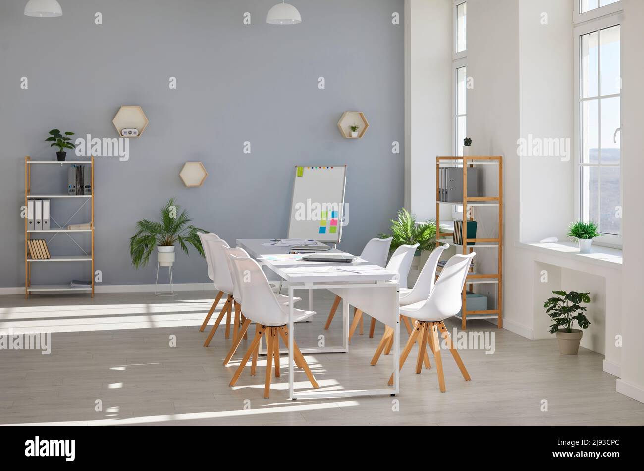 Intérieur de bureau moderne avec table de conférence, chaises, tableau blanc, étagères et plantes d'intérieur Banque D'Images