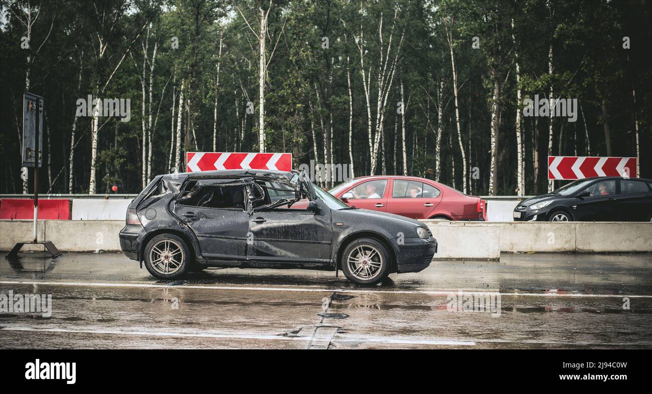 2012: voiture à hayon noir s'est complètement écrasé après le shunt avec un camion en raison de la dérive sur route humide et rétrécie Banque D'Images