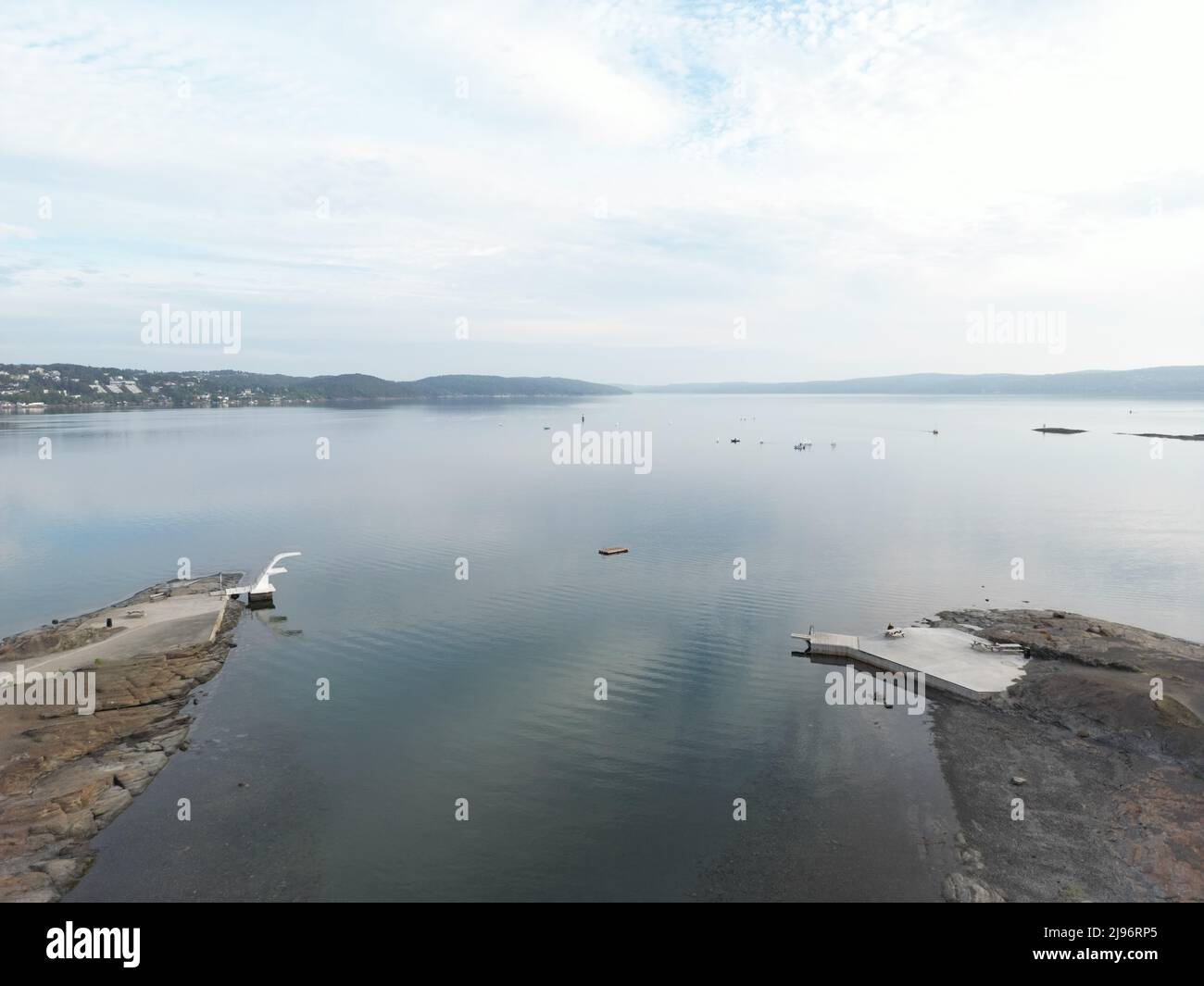 belle photo aérienne d'un paysage comprenant une tour de plongée et une plage, l'eau a un peu de réflexion et vous voyez le fjord en arrière-plan. Banque D'Images