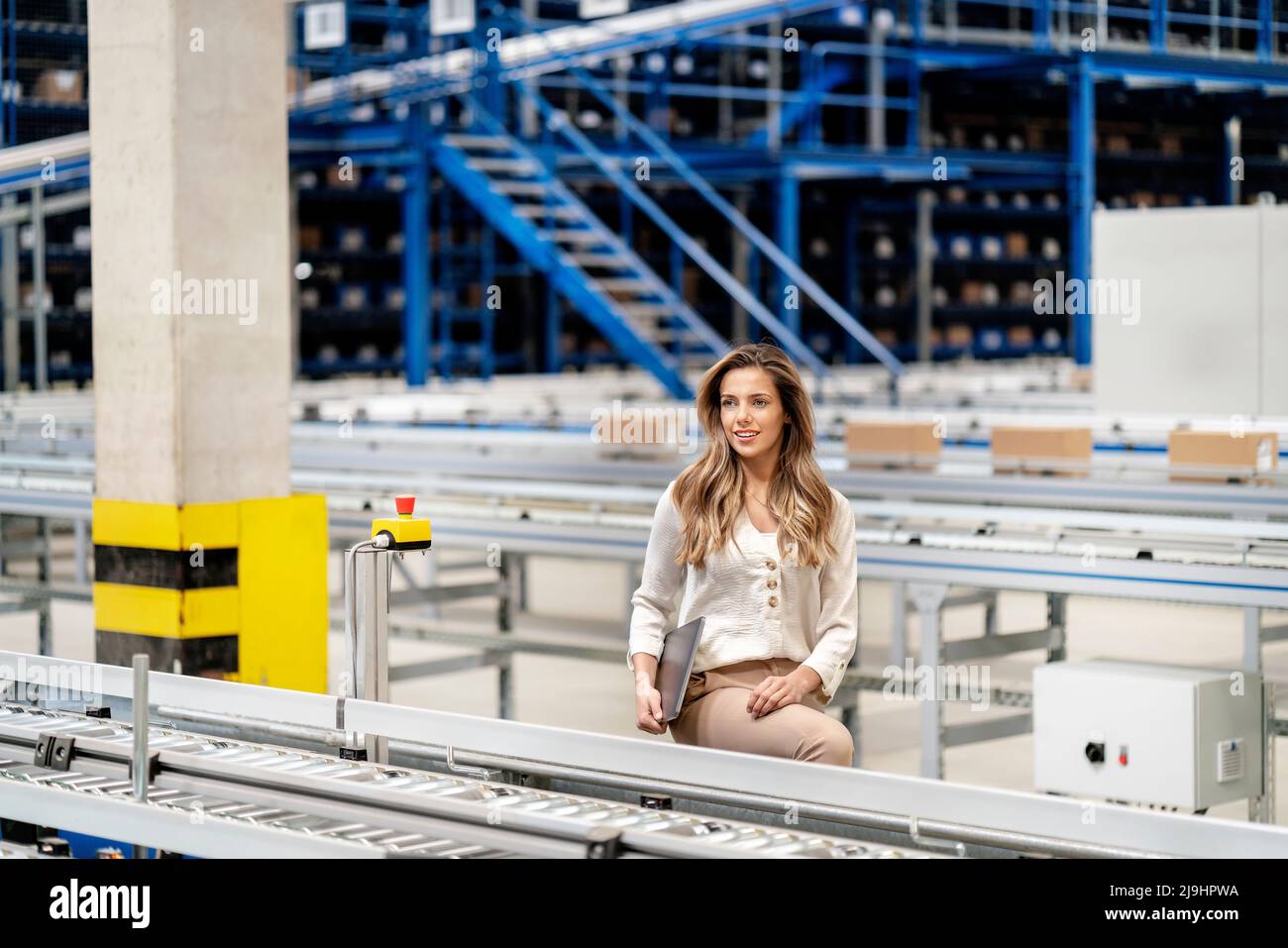 Femme d'affaires attentionnés avec ordinateur portable en usine Banque D'Images
