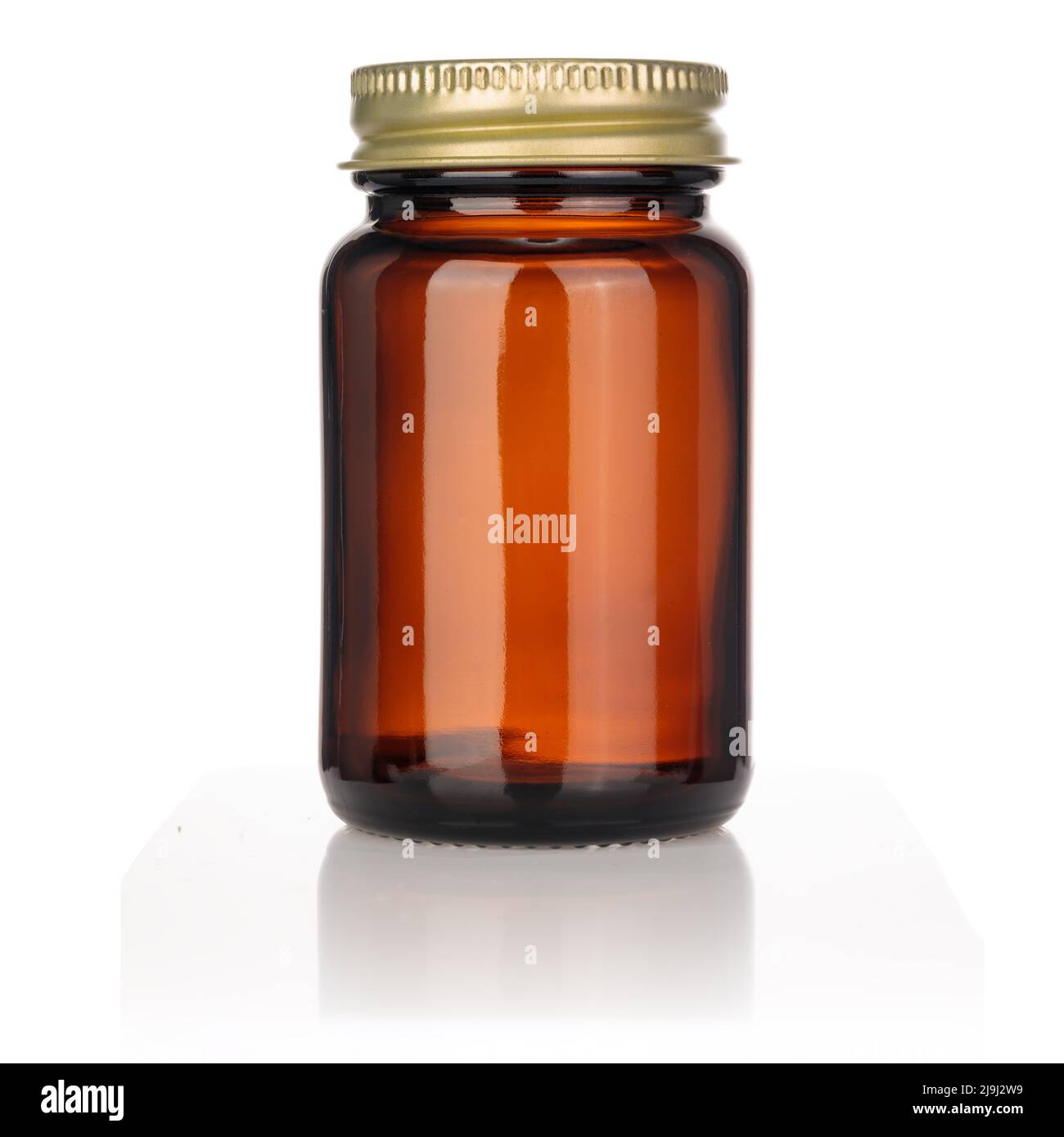 Pot en verre vierge pour comprimés ou pilules sur fond blanc d'isolation. Écrou en métal doré, capuchon. Banque D'Images