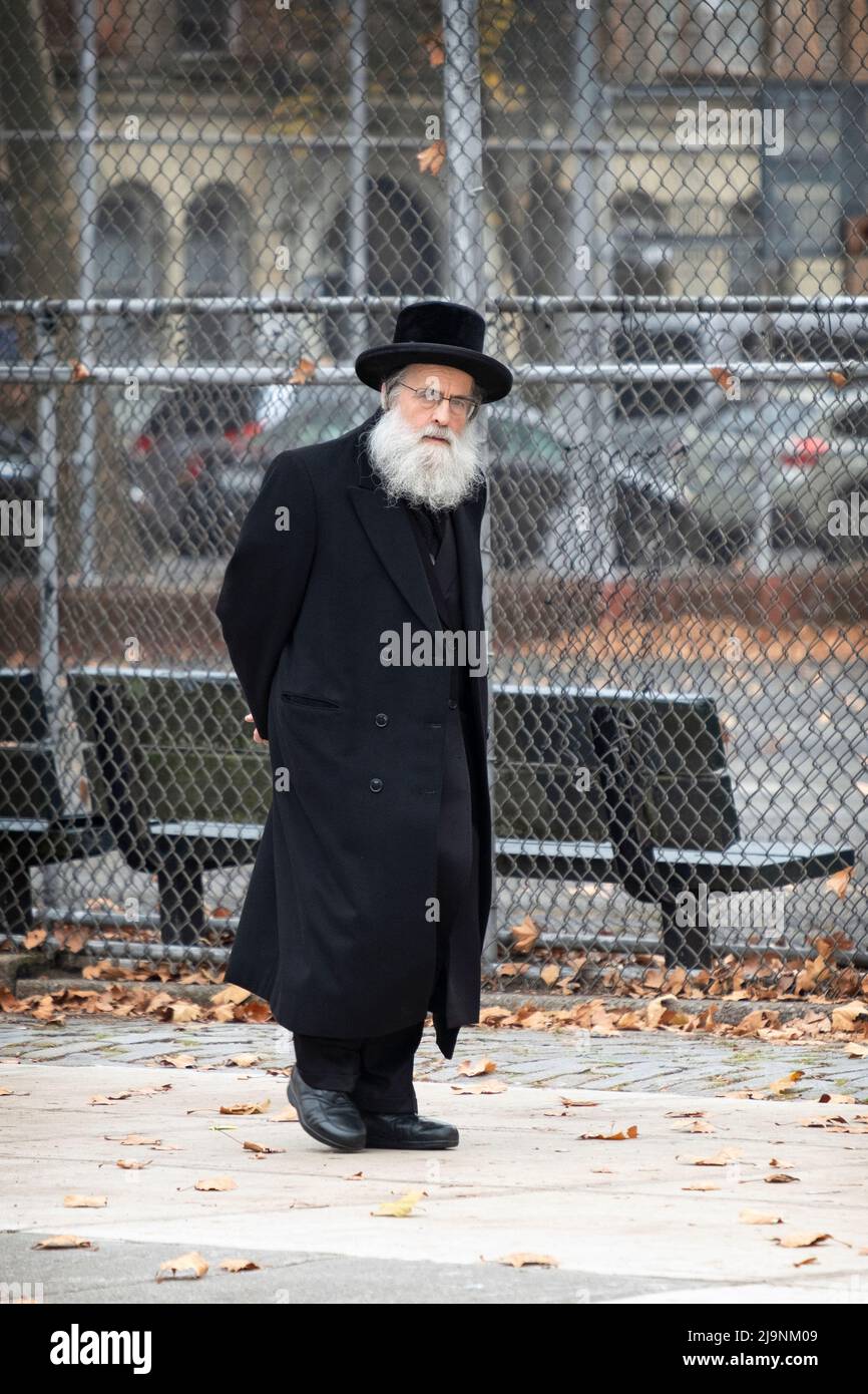 Un juif orthodoxe dans un long manteau noir marche sur Bedford Ave. À  Brooklyn dans un quartier très juif Photo Stock - Alamy