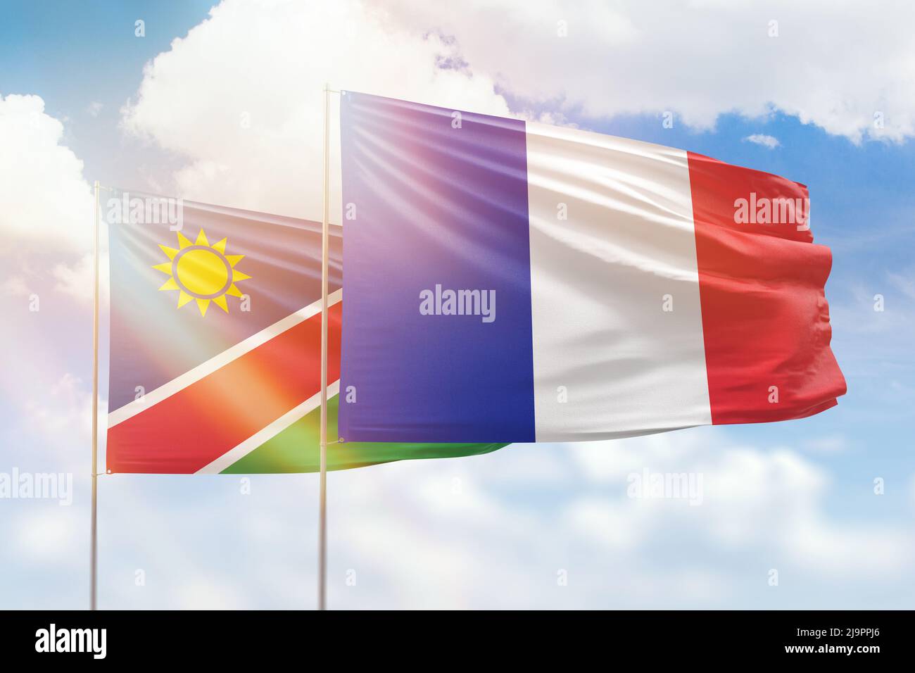 Ciel bleu ensoleillé et drapeaux de la france et de la namibie Banque D'Images