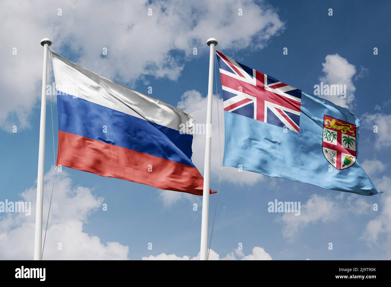 Russie et Fidji deux drapeaux sur les mâts de drapeaux et fond bleu ciel nuageux Banque D'Images