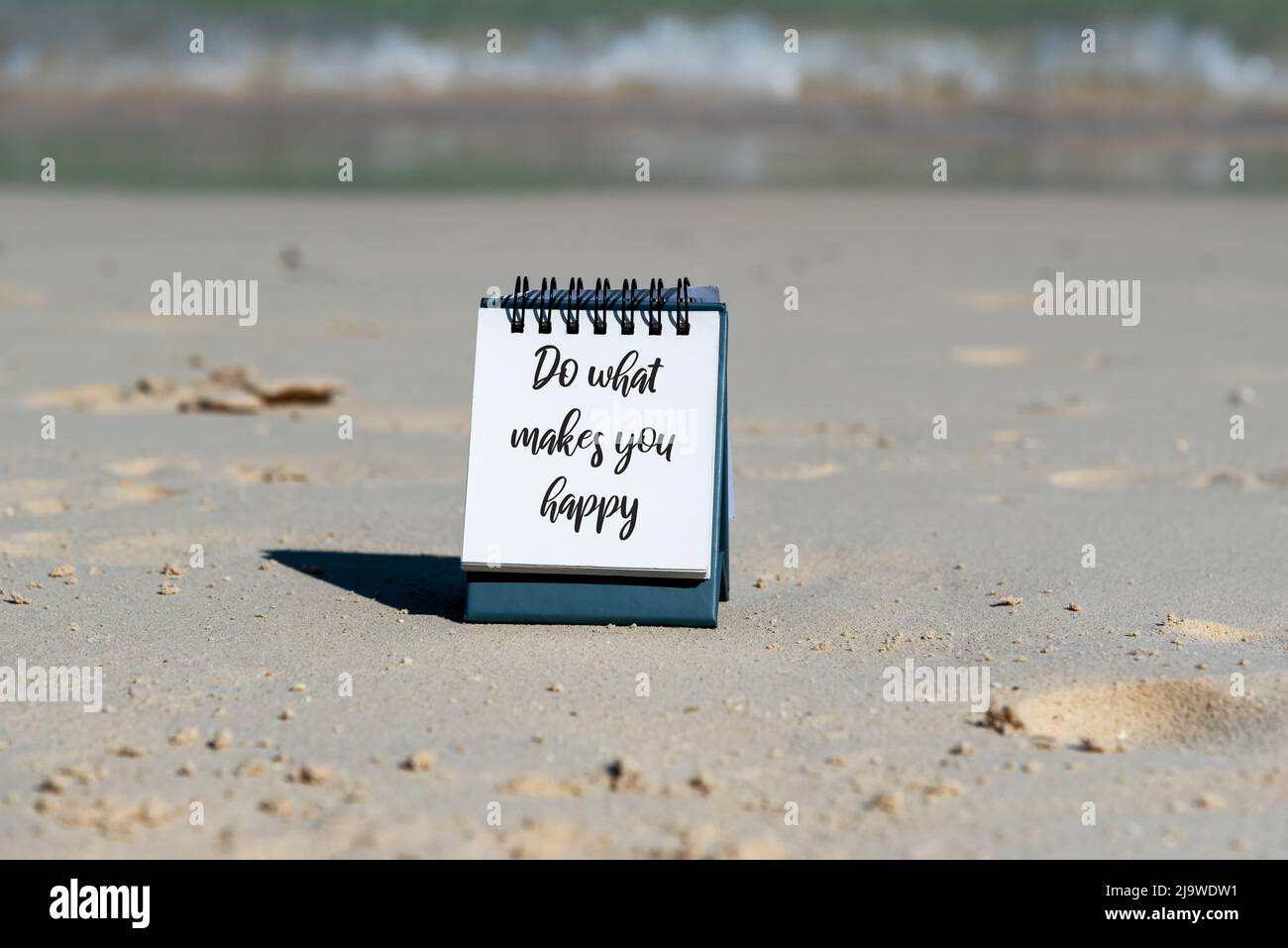 Citations inspirantes - faites ce qui vous rend heureux. Arrière-plan de la plage. Banque D'Images