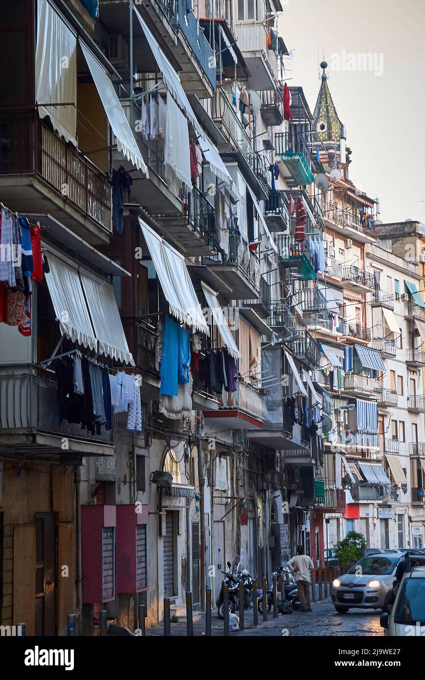 Les auvents offrent une protection contre le soleil impitoyable dans une allée de Naples. Mais la lessive devant les balcons sèche rapidement. Banque D'Images