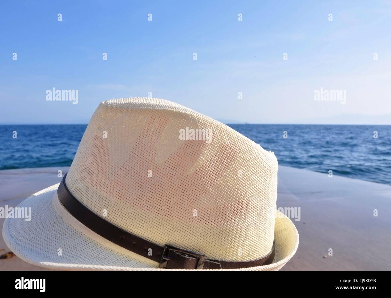 Chapeau posé sur la plage. Horizon Line.Blue Sea et Sky.Woman chapeau de plage contre bleu océan Banque D'Images