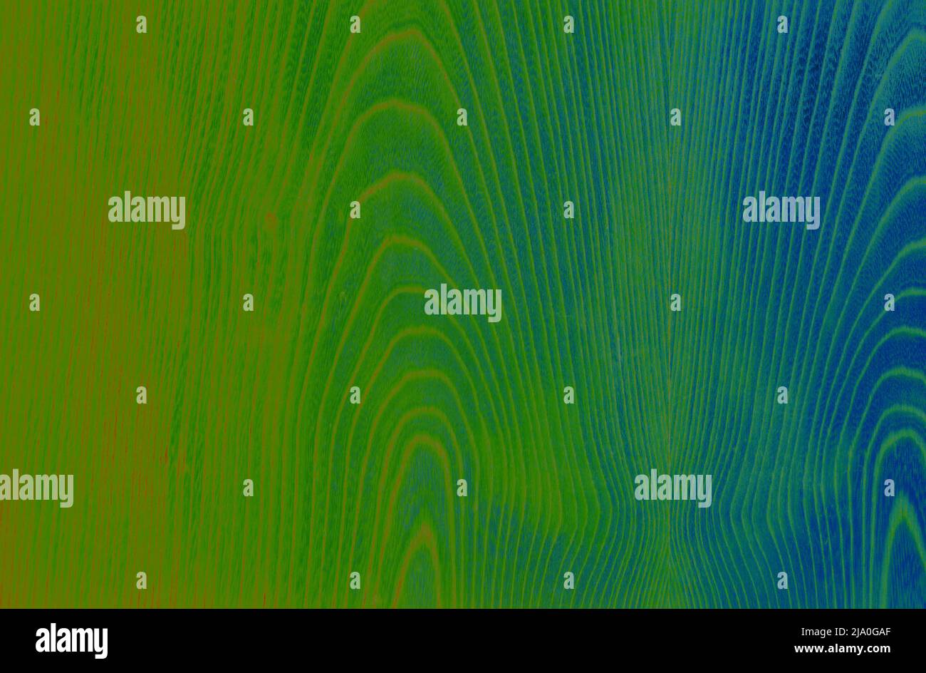 Motif abstrait en bois dans les tons vert, bleu et orange. Traitement artistique de l'image créé à partir de la photo de surface en placage de bois. Belle texture en bois dos Banque D'Images
