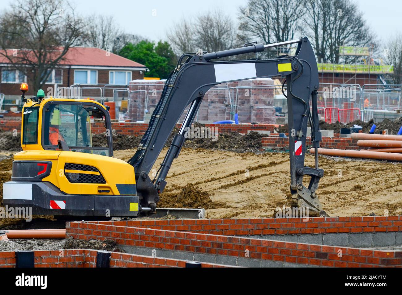 Pelle hydraulique travaillant sur un nouveau chantier de construction de logements résidentiels Banque D'Images