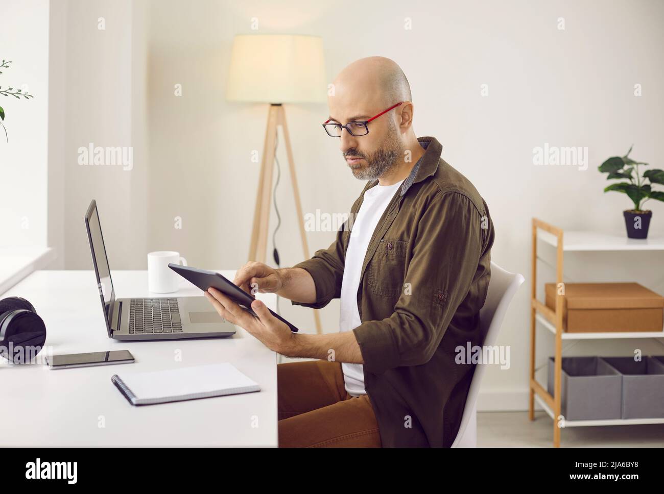 Caucasien freelance travail en ligne sur des gadgets Banque D'Images