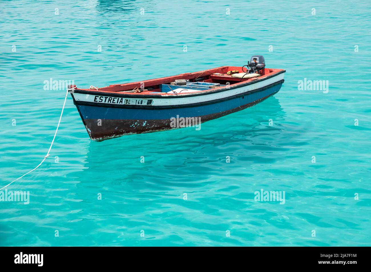 Bateau de pêche en bois rouge, blanc et bleu sur les eaux turquoise de l'Atlantique à Santa Maria, Sal, île du Cap-Vert, îles Cabo Verde, Afrique Banque D'Images