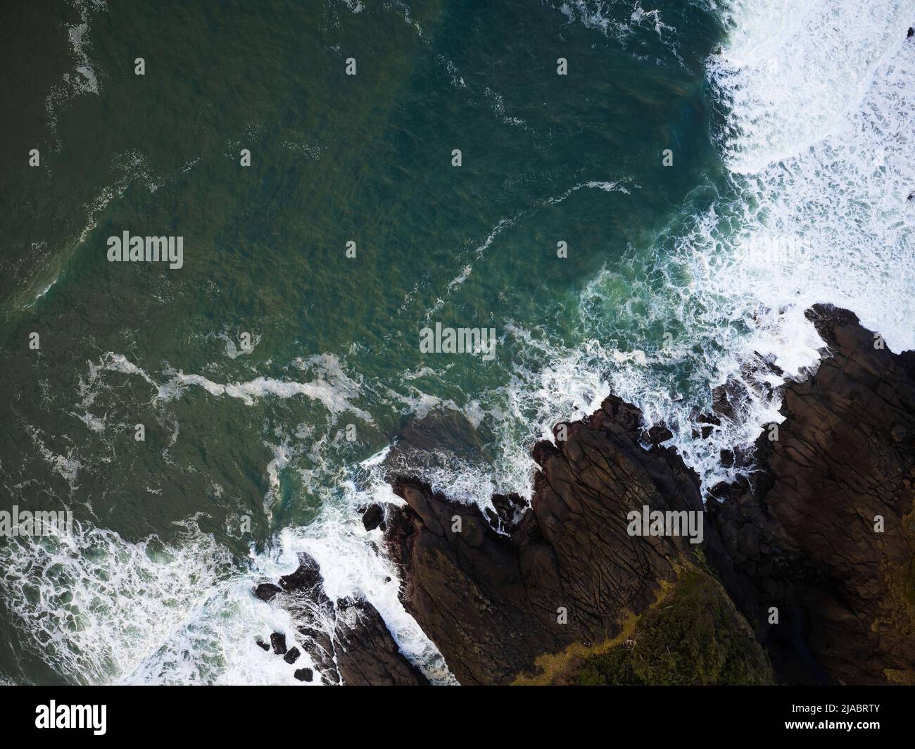 Tir à partir d'un drone. L'eau turquoise transparente de l'océan avec des vagues de lumière bat contre la côte rocheuse. Magnifique paysage marin. Vacances, voyages, Banque D'Images