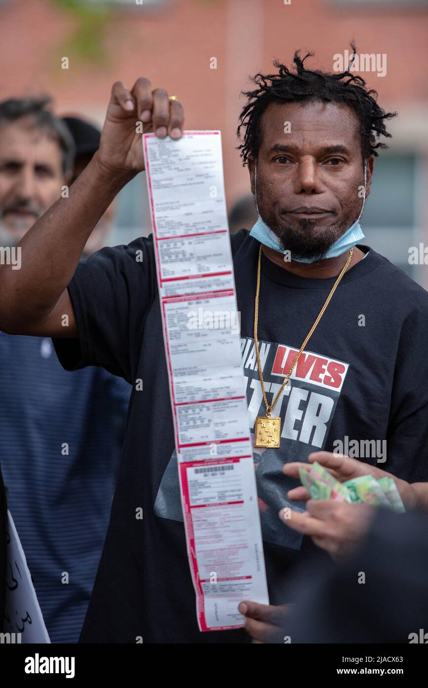 Alexandre Roland, un passant haïtien, a reçu un billet par le SPVM (police de Montréal) après avoir sonné le klaxon de sa voiture pour soutenir la manifestation, après quoi il a rejoint la manifestation et a mis un t-shirt disant: "Les vies algériennes comptent". Les manifestants algériens ont rapidement recueilli de l'argent pour aider à payer son billet. Quatre ans après son entrée dans la diaspora algérienne, le mouvement Hirak continue de lutter pour la démocratie à Montréal. Organisé par tous nos Unis pour notre Algerie, des centaines de manifestants se sont rassemblés devant le Consulat algérien pour demander la destitution des dirigeants politiques actuels, dirigés par le président AB Banque D'Images