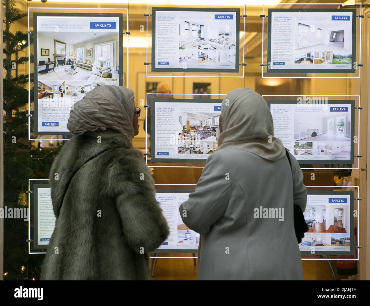 Photo du dossier datée du 04/12/14 des membres du public regarde dans la fenêtre d'un agent immobilier à South Kensington, Londres, comme le prix moyen d'une maison britannique a dépassé £250 000 pour la première fois, mais la proportion de vendeurs appliquant des remises aux propriétés augmente, selon un indice. Banque D'Images