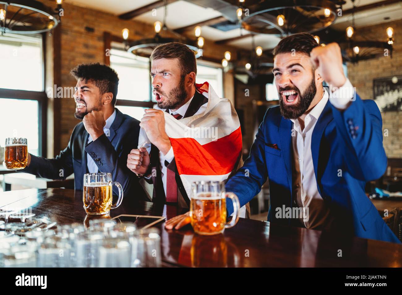 Des fans d'hommes hurlent et regardaient le football à la télévision et ...