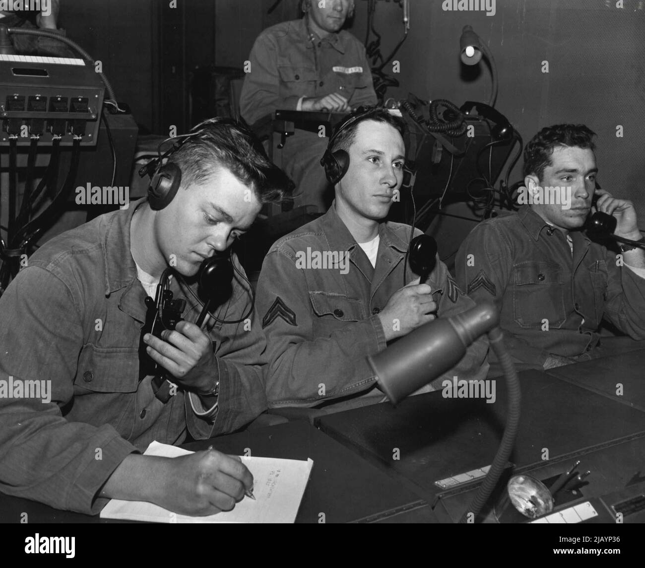 Regardez les Skies -- au moment où les batteries des balayeuses du ciel entrent en action, les techniciens d'un centre d'opérations, fort Bliss, Texas, totalisent les informations de tir reçues des unités du bataillon d'artillerie antiaérienne de 531st. De gauche à droite : Pvt. Charles R. Jones, fort Worth, Texas; Cpl. Robert Enders, silex, Michigan et Cpl. Cyril Brown, Oklahoma. 06 décembre 1954. (Photo par photo officielle de l'armée américaine). Banque D'Images