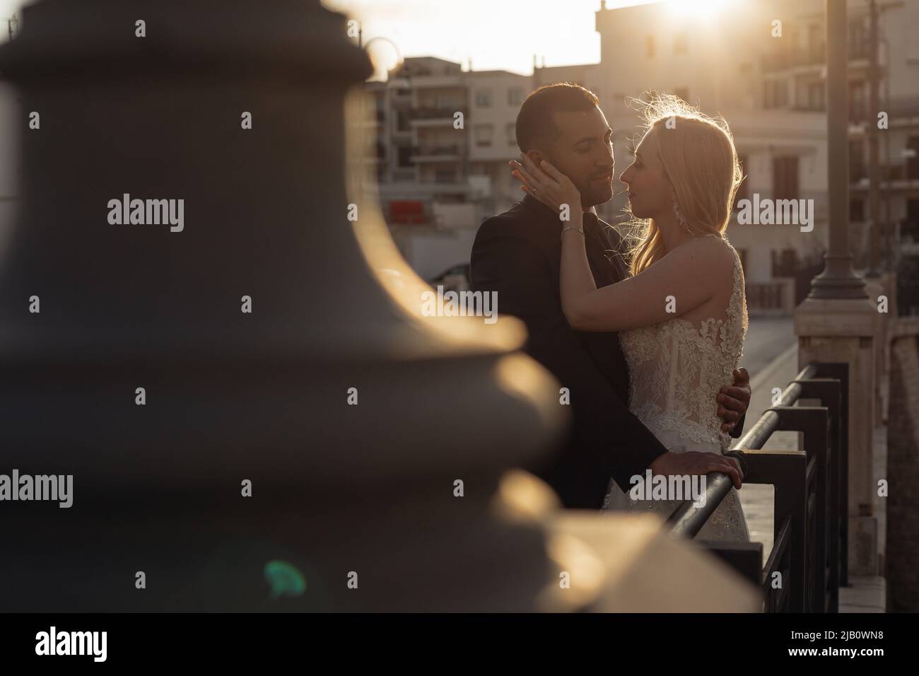 Couple marié amoureux romantique sur la vue arrière dans la lumière du coucher du soleil, embrassez et touchez ensemble. Amour vrai. Vacances en Italie Banque D'Images