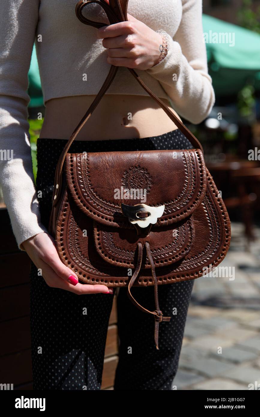 petit sac en cuir marron pour femmes avec un motif sculpté. photo de rue Banque D'Images
