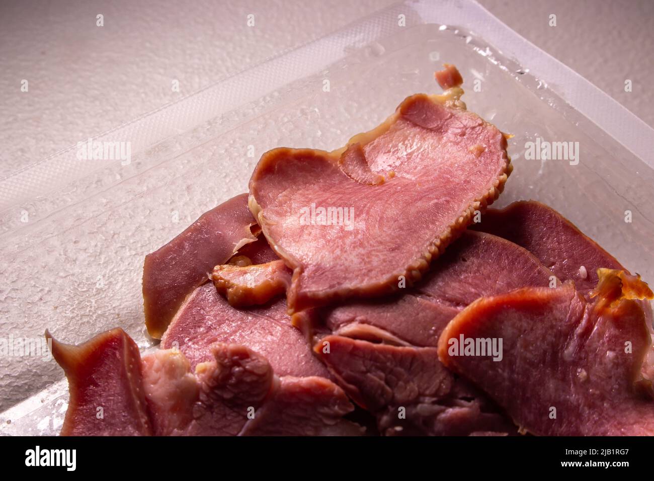 Les tranches de languettes de boeuf fumées dans l'emballage dans l'emballage en plastique vendu par le supermarché local au Japon sur la table. Banque D'Images