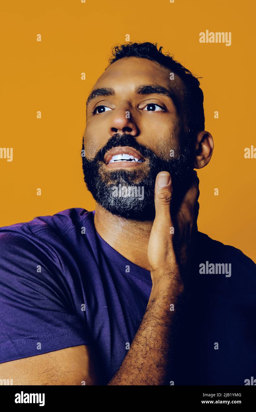 gros plan d'un homme adulte sensible et attentif avec une barbe et une main  de moustache sur le menton en regardant loin dans l'espace de copie jaune  studio Photo Stock - Alamy