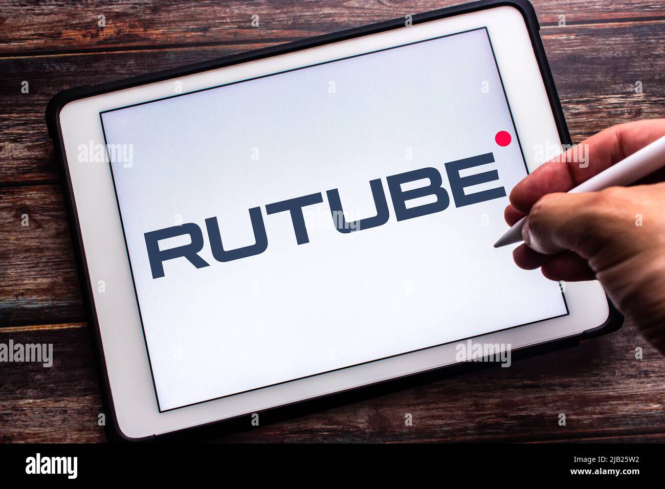Kumamoto, JAPON - 12 mai 2022 : Un signe de Rutube, une plate-forme vidéo russe appartenant à Gazprom-Media, sur une tablette sur une table. Homme main tenant le stylet Banque D'Images