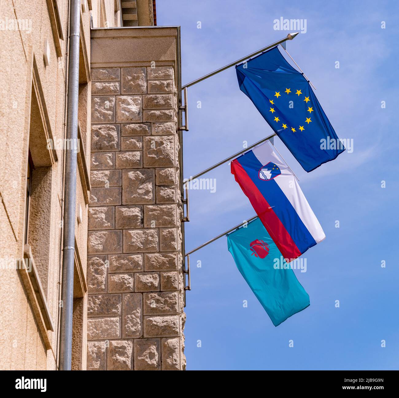 Une photo des drapeaux sur la façade d'un bâtiment gouvernemental à Nova Gorica, en Slovénie. Banque D'Images