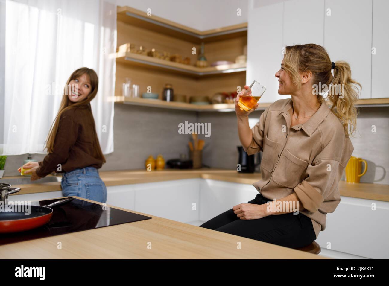 Jolie fille aidant sa mère dans la cuisine Banque D'Images