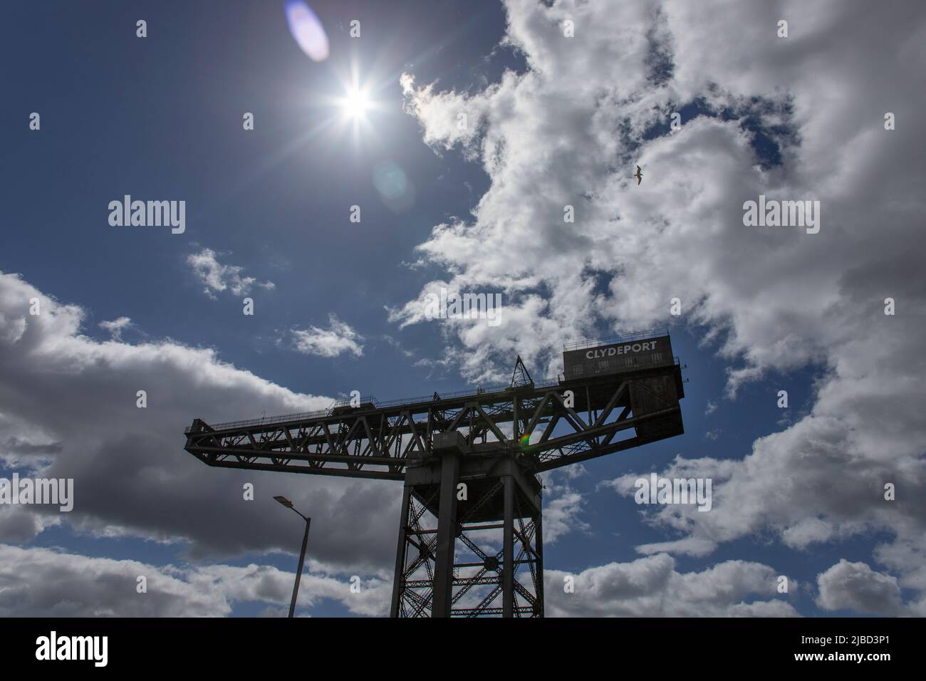 La grue Finnieston (Stobcross), grue géante en porte-à-faux sur les rives de la Clyde à Glasgow, en Écosse. Ciel lumineux et nuages derrière. Banque D'Images
