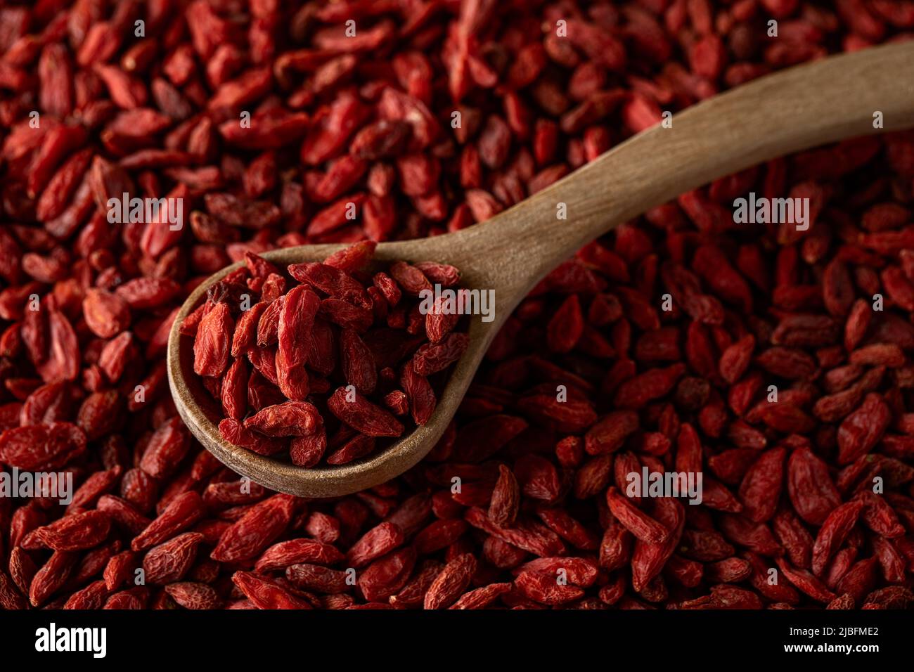 Vue de dessus d'une cuillère en bois pleine de baies de goji Banque D'Images